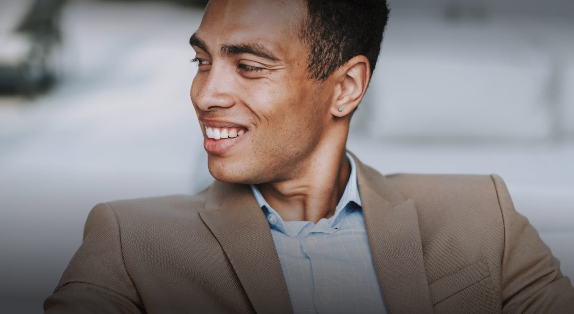 Smiling man wearing a suit indoors.